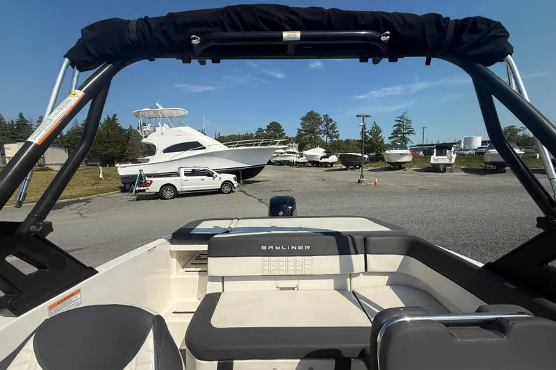 Slide: The Image of 2019 Bayliner VR5 Bowrider OB in a marina with other boats and a truck. - 10