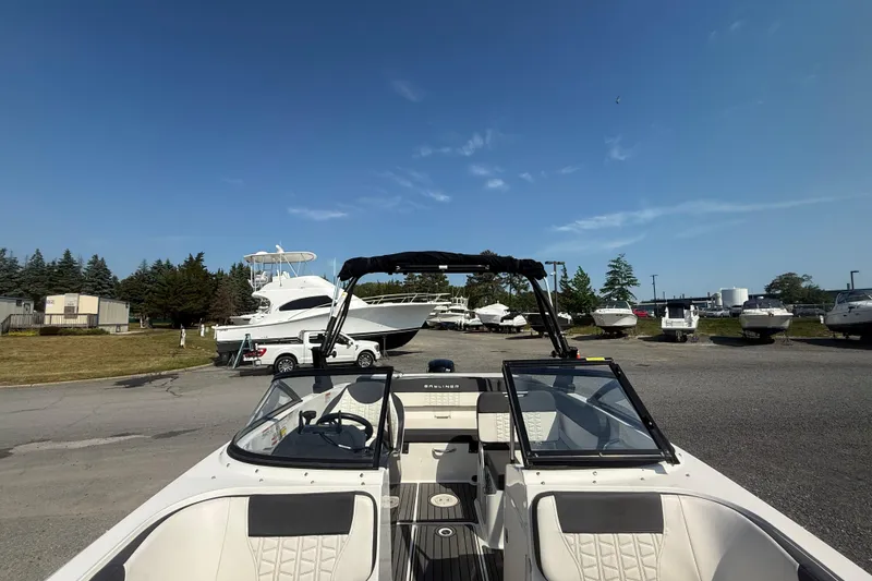 Slide: The Image of 2019 Bayliner VR5 Bowrider OB in marina, surrounded by other boats under clear blue sky. - 11