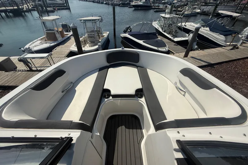Slide: The Image of 2019 Bayliner VR5 Bowrider OB at marina, showcasing spacious seating and sleek design. - 12