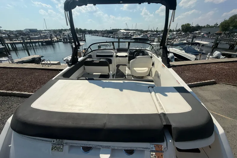 Slide: The Image of 2019 Bayliner VR5 Bowrider OB at marina, showcasing spacious seating and sleek design. - 5