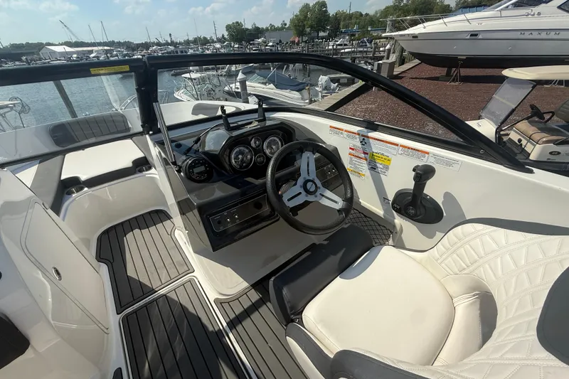 Slide: The Image of 2019 Bayliner VR5 Bowrider OB interior with steering wheel and dashboard, docked at marina. - 8