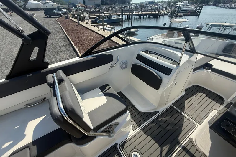Slide: The Image of 2019 Bayliner VR5 Bowrider OB interior with sleek seating and modern design at a marina. - 9