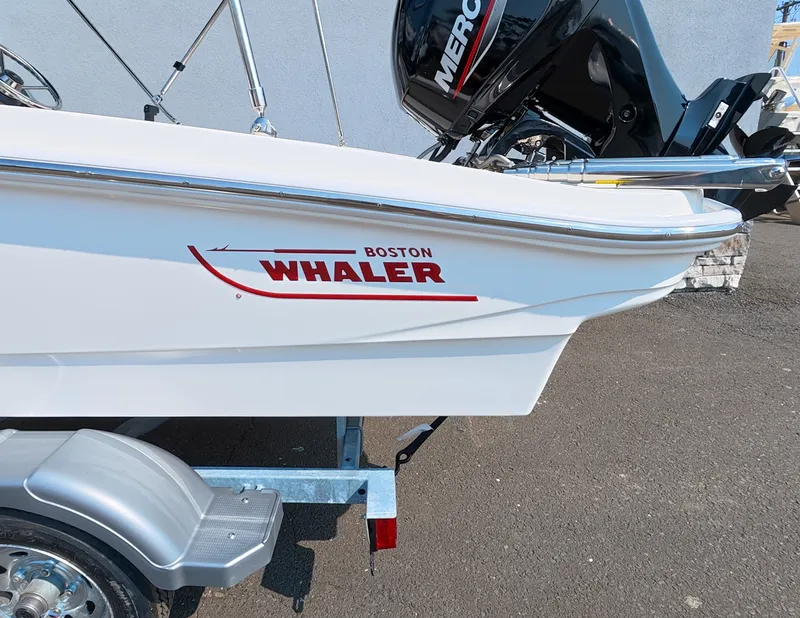 Slide: The Image of A 2027 Boston Whaler 130 Super Sport on a trailer, featuring a Mercury engine. - 4
