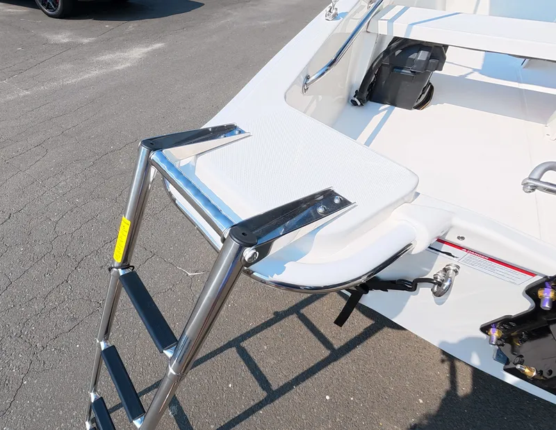 Slide: The Image of A 2027 Boston Whaler 130 Super Sport with a retractable swim ladder at the stern. - 6
