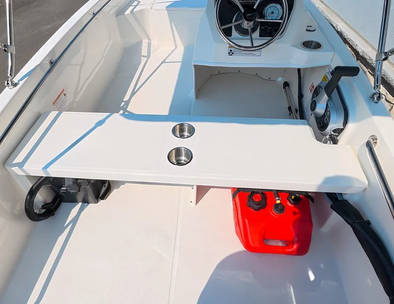Slide: The Image of The image shows the cockpit of a 2027 Boston Whaler 130 Super Sport with a helm and red fuel tank. - 8