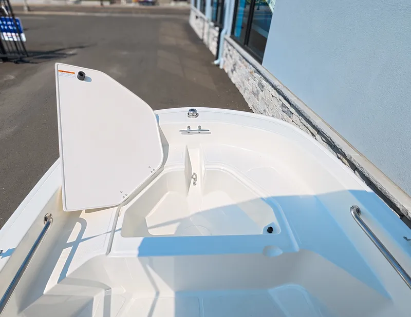 Slide: The Image of The image shows the deck of a 2027 Boston Whaler 130 Super Sport with white surfaces. - 13
