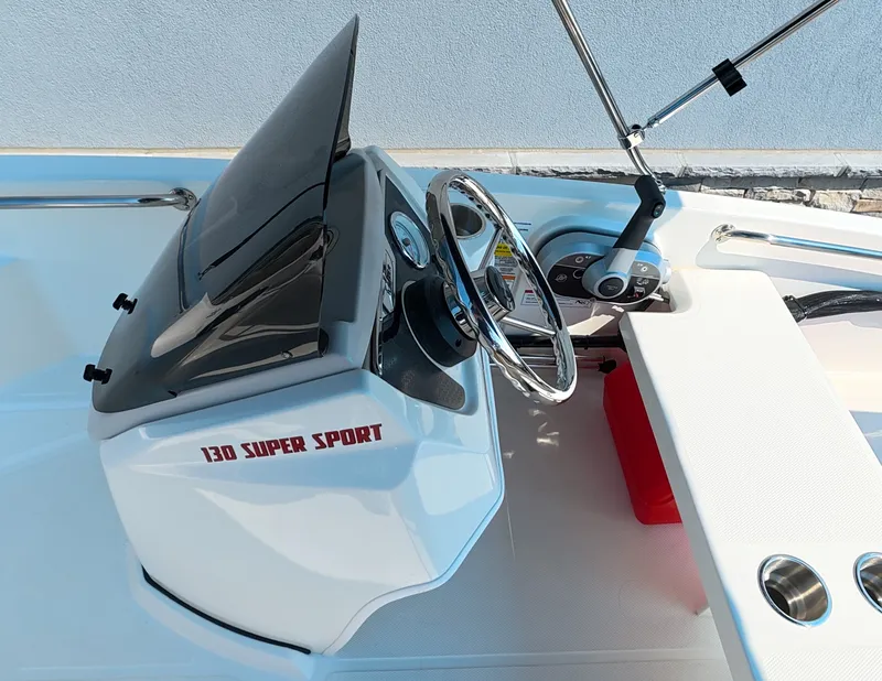 Slide: The Image of The image shows the cockpit of a 2027 Boston Whaler 130 Super Sport with a modern helm. - 9