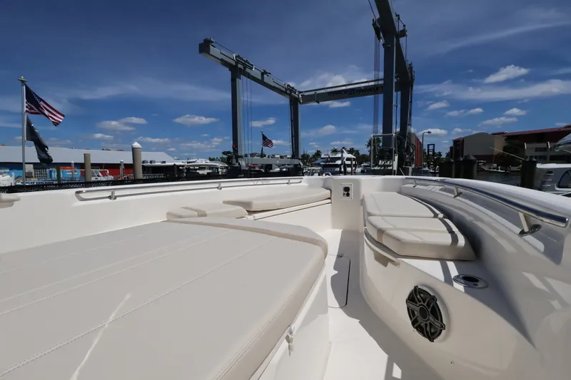 Slide: The Image of The image shows the deck of a 2027 Boston Whaler 280 Dauntless with beige upholstery. - 15
