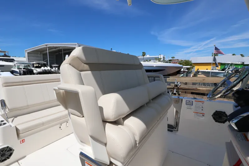 Slide: The Image of The 2027 Boston Whaler 280 Dauntless features a luxurious, cushioned outdoor seating area. - 9