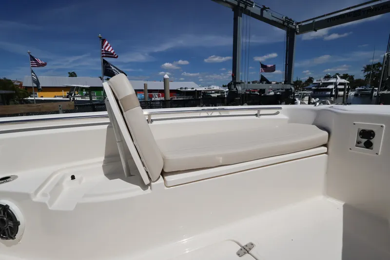 Slide: The Image of The 2027 Boston Whaler 280 Dauntless features a spacious outdoor bench seat with beige upholstery. - 18