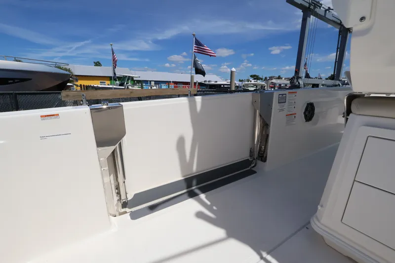 Slide: The Image of The image shows the deck of a Boston Whaler 280 Dauntless with an open door and flags in the background. - 11