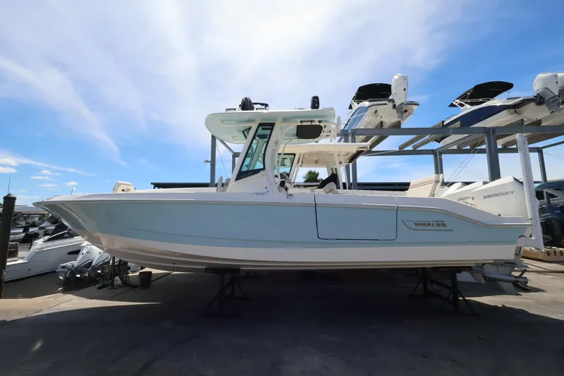 Slide: The Image of A 2027 Boston Whaler 280 Dauntless is on a dry dock. The sky is clear. - 1
