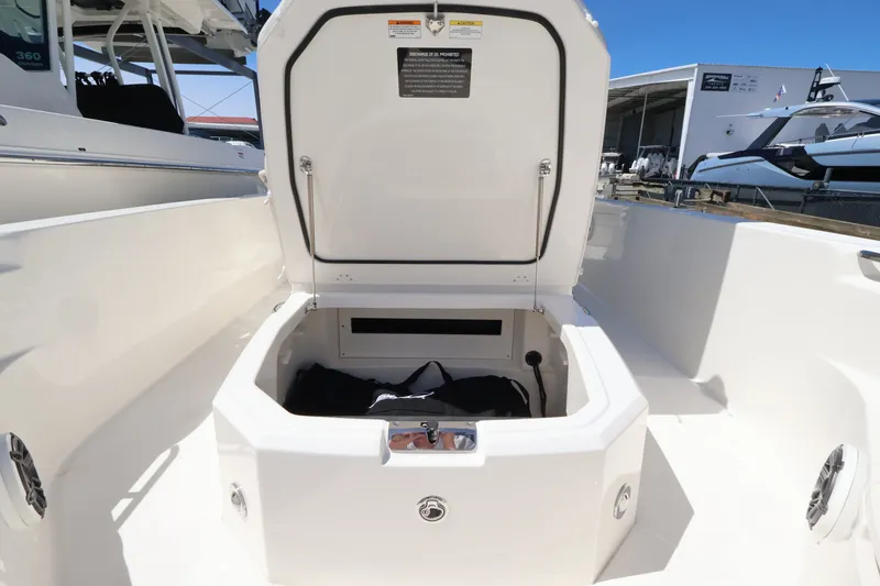 Slide: The Image of The image shows an open storage compartment on a Boston Whaler 280 Dauntless boat. - 20