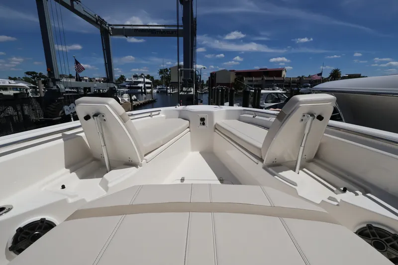 Slide: The Image of The image shows the deck of a 2027 Boston Whaler 280 Dauntless in a marina. - 16