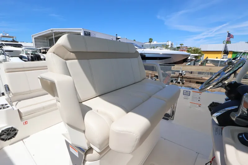 Slide: The Image of The 2027 Boston Whaler 280 Dauntless features a spacious, cushioned bench seat in the cockpit. - 8