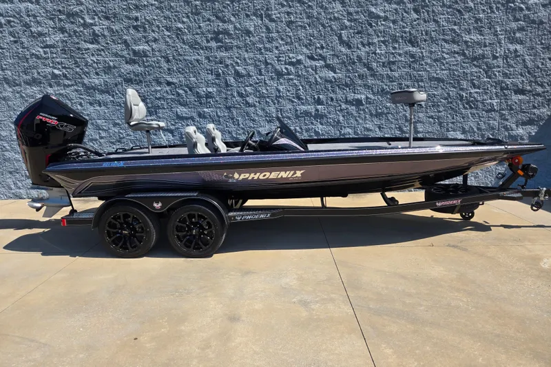 The Image of 2026 Phoenix 921 Elite X fishing boat on trailer, parked outdoors. - 1