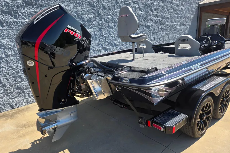 Slide: The Image of 2026 Phoenix 921 Elite X boat with Mercury Pro XS engine, parked on a trailer. - 2