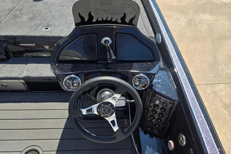 Slide: The Image of 2026 Phoenix 921 Elite X boat dashboard with steering wheel and control panel. - 5