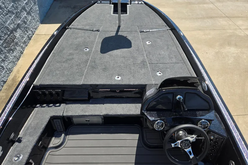 Slide: The Image of 2026 Phoenix 921 Elite X boat interior with spacious deck and modern steering console. - 6