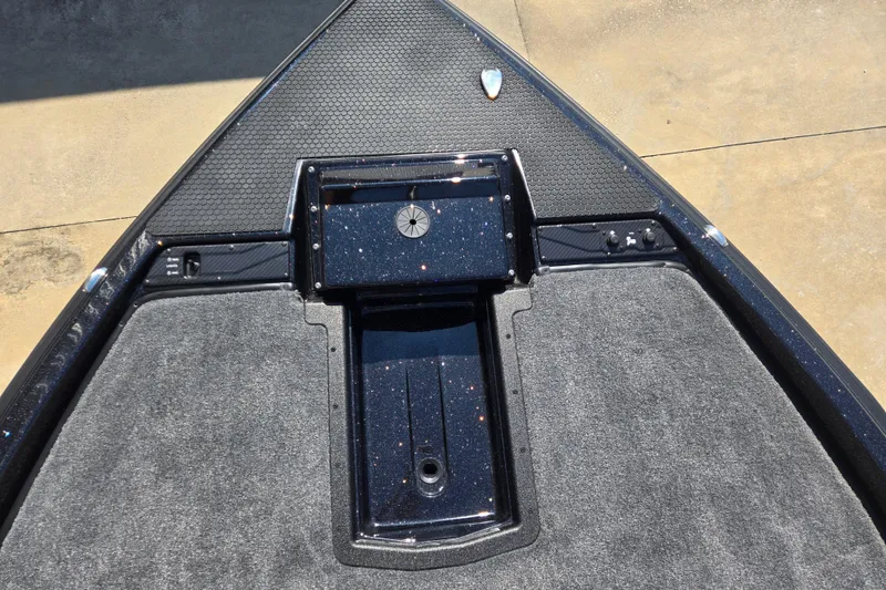 Slide: The Image of Bow deck of 2026 Phoenix 921 Elite X boat with textured surface and storage compartment. - 7