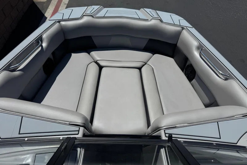 Slide: The Image of 2022 Moomba Max boat interior with gray cushioned seating and sleek design. - 10