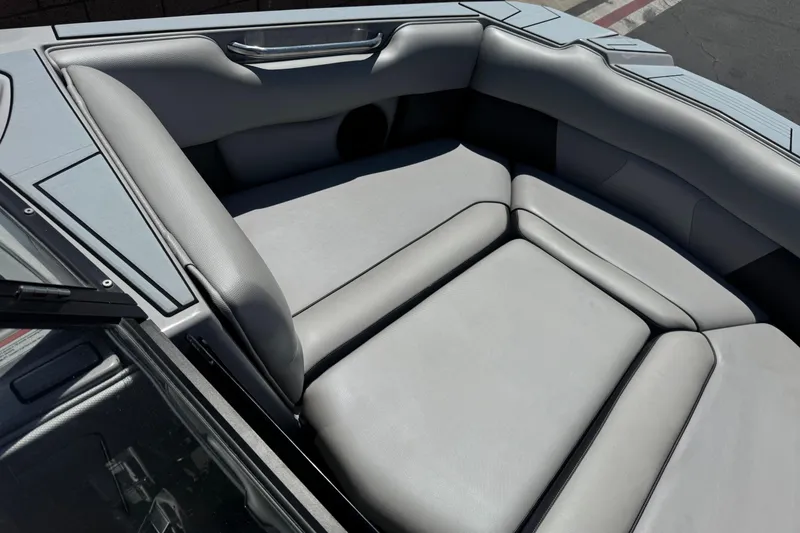 Slide: The Image of Interior seating of a 2022 Moomba Max boat, featuring sleek gray upholstery. - 11