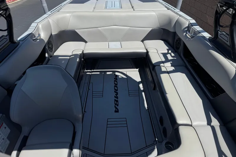 Slide: The Image of 2022 Moomba Max boat interior with gray seating and spacious layout. - 16