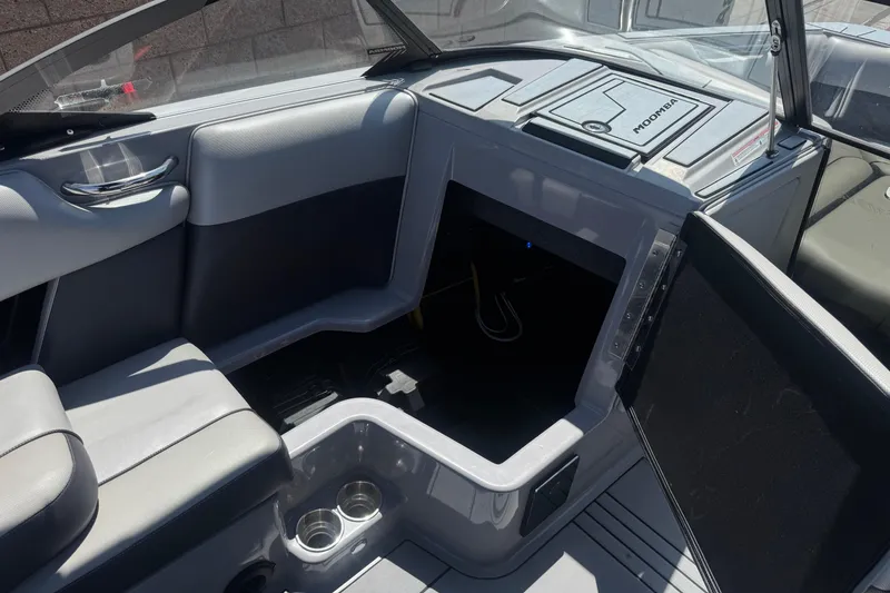 Slide: The Image of Interior of a 2022 Moomba Max boat featuring seating and storage compartments. - 23