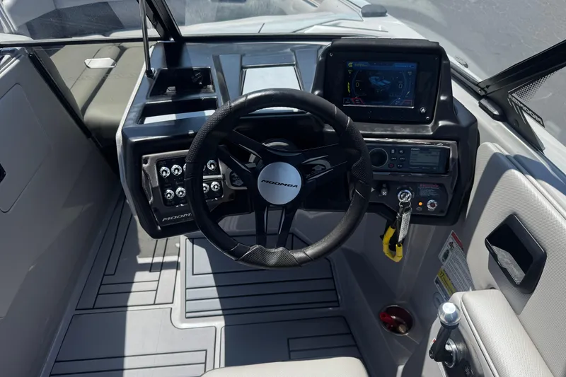 Slide: The Image of 2022 Moomba Max boat dashboard with steering wheel and control panel. - 27