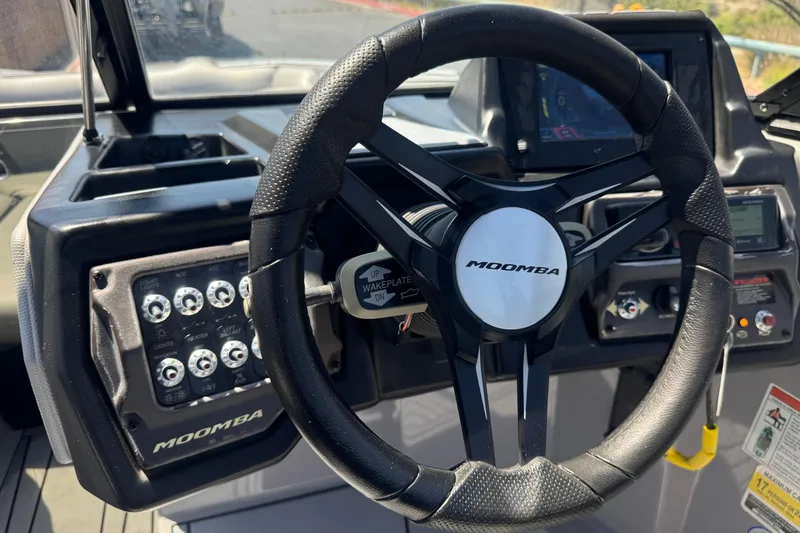 Slide: The Image of 2022 Moomba Max boat dashboard with steering wheel and control panel. - 31
