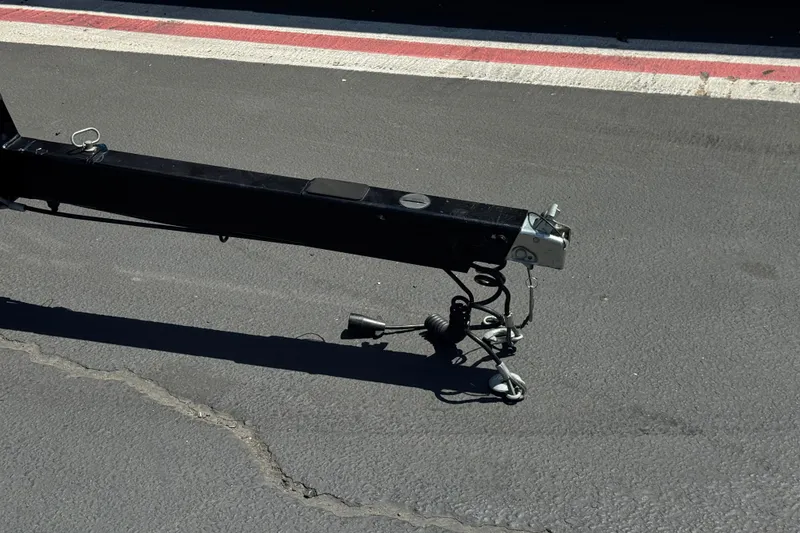 Slide: The Image of Trailer hitch of a 2022 Moomba Max on asphalt pavement. - 33