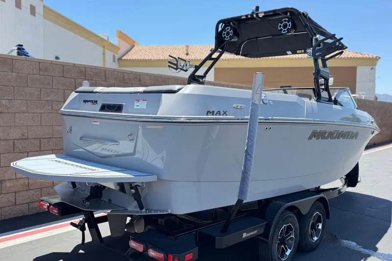 Slide: The Image of 2022 Moomba Max boat on trailer, featuring sleek design and Raptor engine. - 5