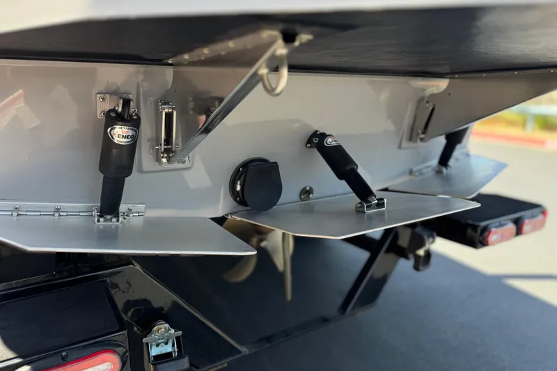 Slide: The Image of 2022 Moomba Max boat with trim tabs and hydraulic actuators, rear view. - 7