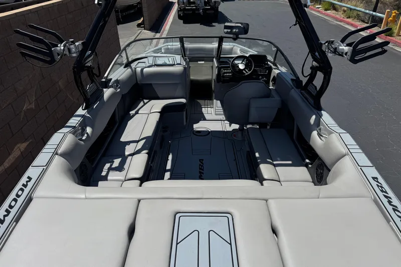 Slide: The Image of 2022 Moomba Max boat interior with spacious seating and modern dashboard design. - 8
