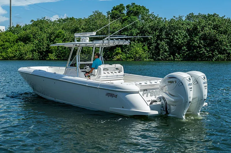 Slide: The Image of 2020 Intrepid 345 Nomad FE boat cruising on a sunny day with twin Yamaha engines. - 11
