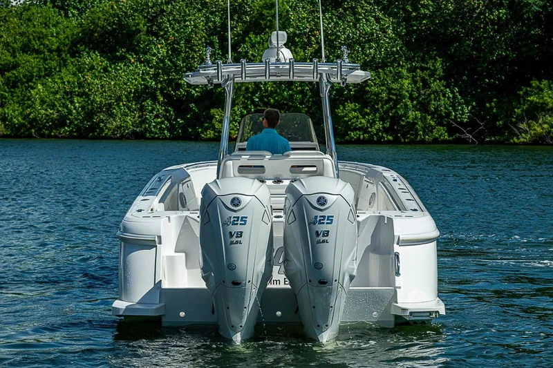 Slide: The Image of 2020 Intrepid 345 Nomad FE boat with dual Yamaha 425 V8 engines on water. - 12