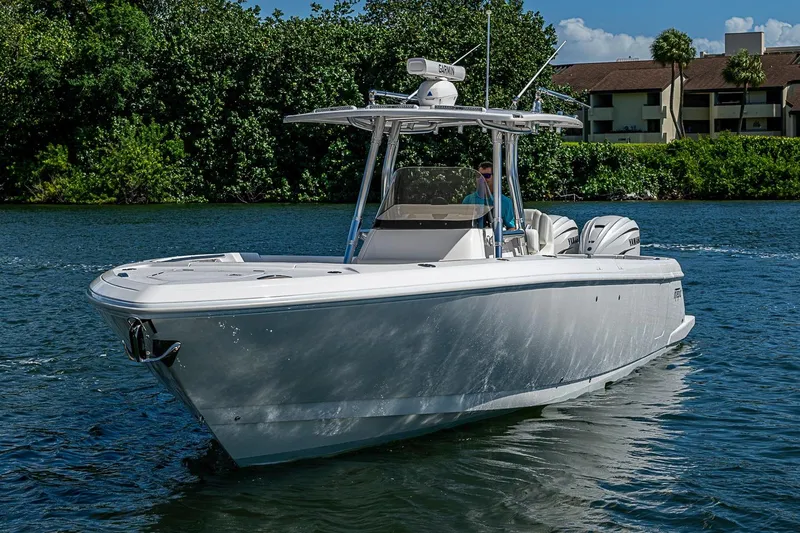 Slide: The Image of 2020 Intrepid 345 Nomad FE boat cruising on a scenic waterway. - 23