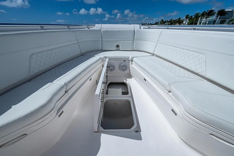 Slide: The Image of 2020 Intrepid 345 Nomad FE boat interior with white seating and storage compartments. - 27