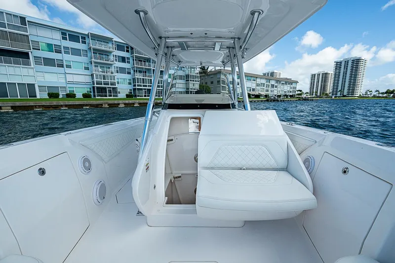 Slide: The Image of 2020 Intrepid 345 Nomad FE boat interior with luxurious seating, dockside view. - 28