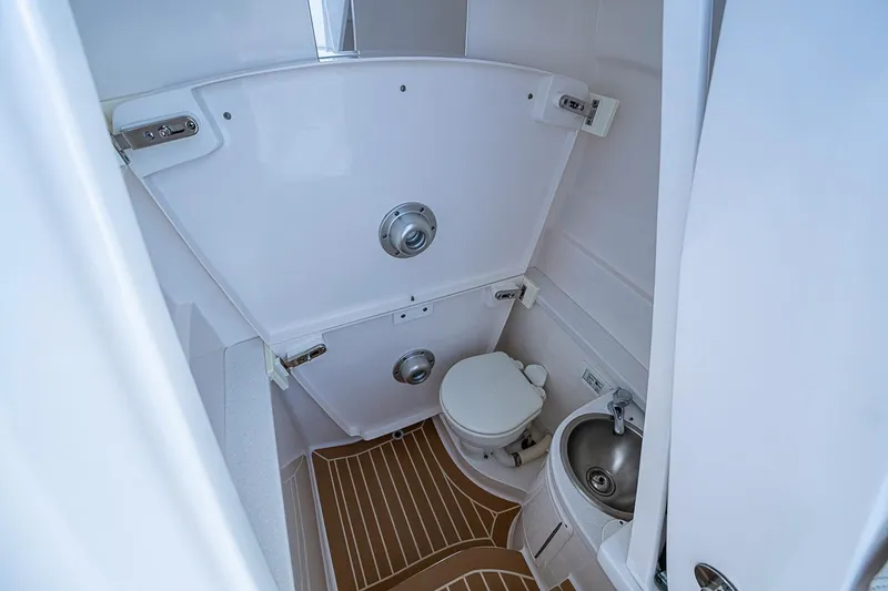 Slide: The Image of Compact bathroom in 2020 Intrepid 345 Nomad FE boat with toilet and sink. - 29