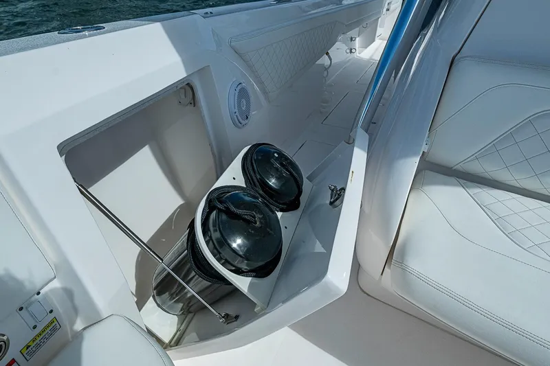Slide: The Image of Interior view of 2020 Intrepid 345 Nomad FE boat with storage compartment and seating. - 31