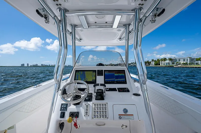 Slide: The Image of Cockpit view of 2020 Intrepid 345 Nomad FE boat on open water. - 36