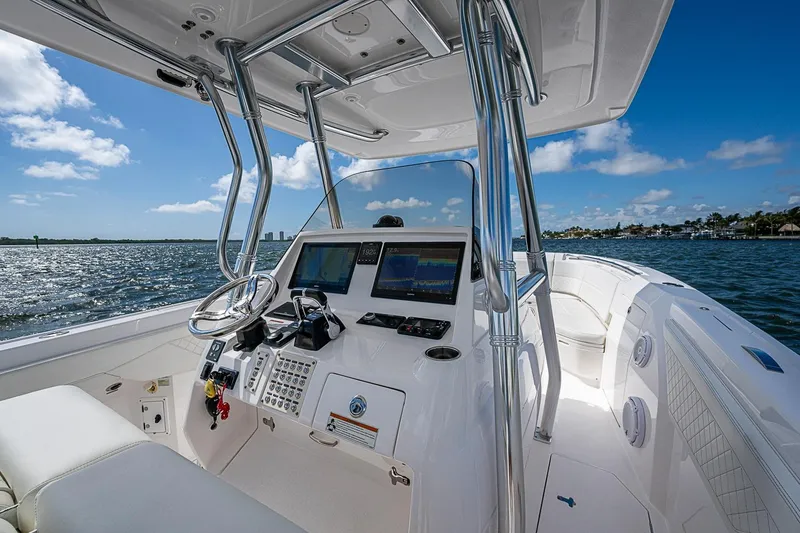 Slide: The Image of Intrepid 345 Nomad FE 2020 boat helm with ocean view, featuring modern navigation equipment. - 37