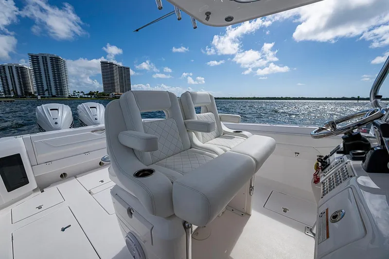 Slide: The Image of 2020 Intrepid 345 Nomad FE boat interior with luxurious seating and ocean view. - 40