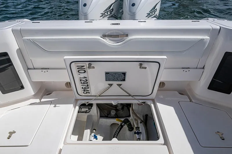 Slide: The Image of 2020 Intrepid 345 Nomad FE boat with open hatch revealing storage compartment. - 47
