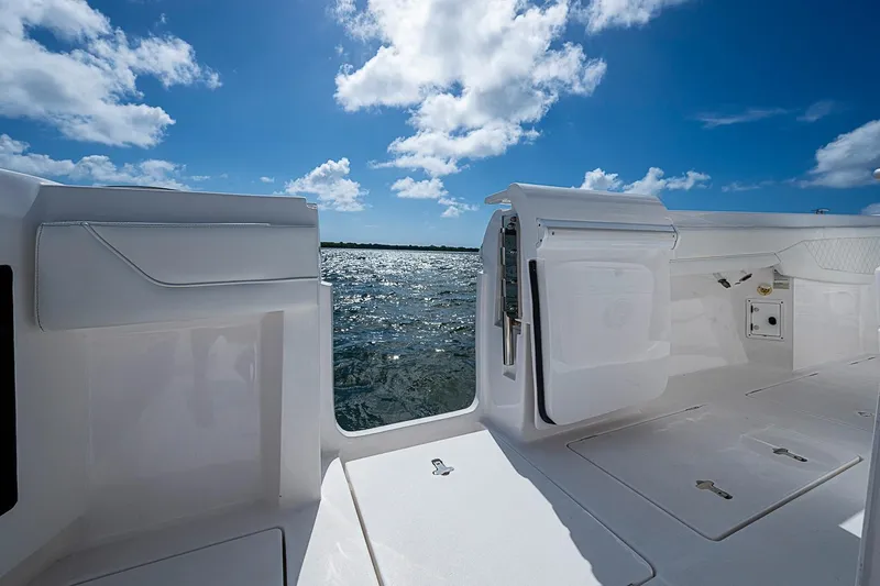 Slide: The Image of 2020 Intrepid 345 Nomad FE boat interior with ocean view under blue sky. - 49