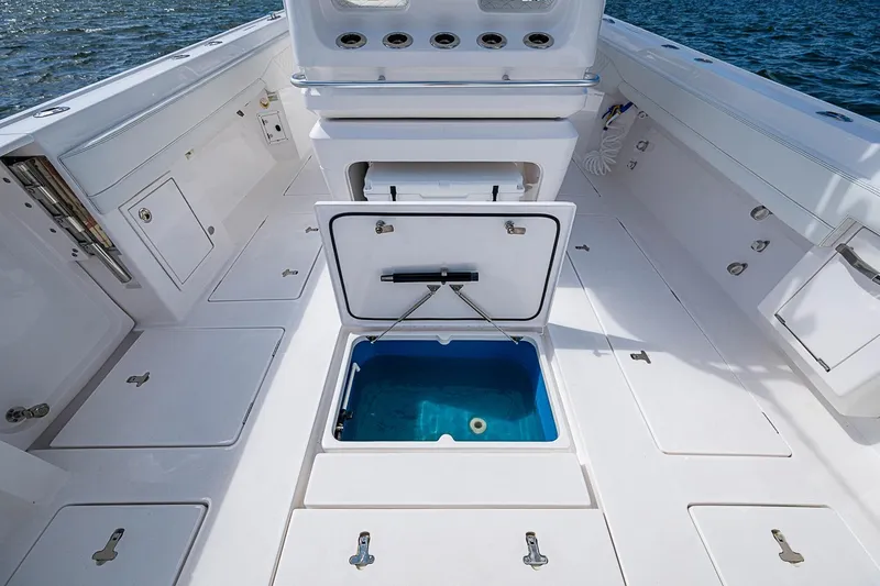 Slide: The Image of 2020 Intrepid 345 Nomad FE boat deck with open storage compartments and ocean view. - 50