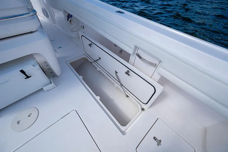 Slide: The Image of 2020 Intrepid 345 Nomad FE boat with open storage compartment on deck. - 52