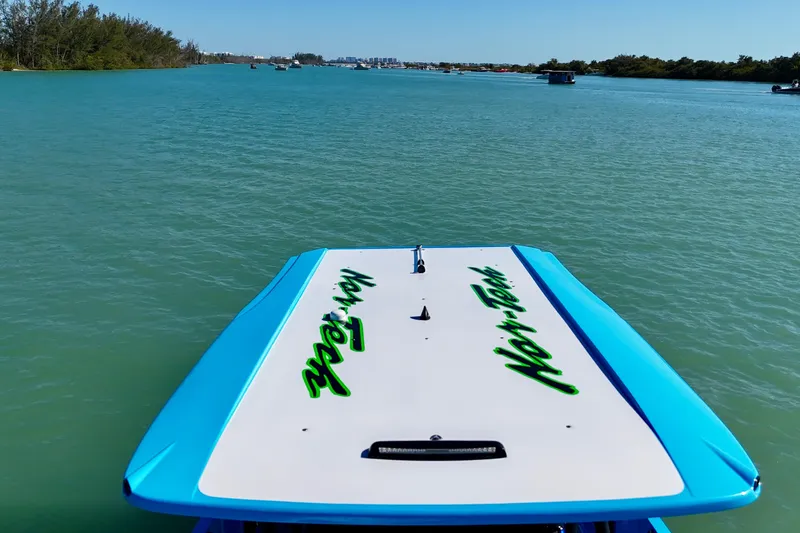 Slide: The Image of 2026 Nor-Tech 390 Sport Center Console on serene blue waters, showcasing sleek design. - 13
