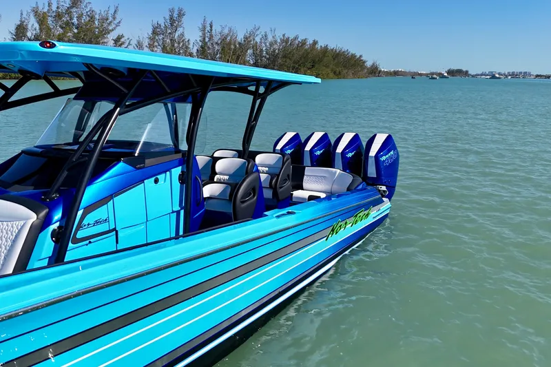 Slide: The Image of 2026 Nor-Tech 390 Sport Center Console boat on calm water, featuring vibrant blue design. - 14